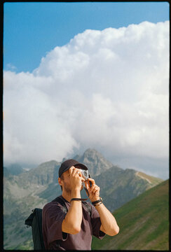 A photographer takes pictures on a mountain hike