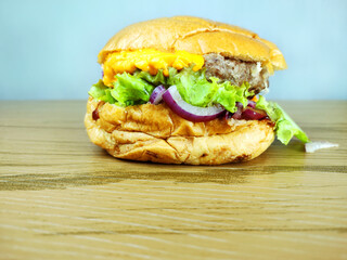 Craft burger on the wooden table and with copy space and white background