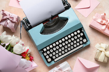 Festive composition with typewriter, bouquet of flowers and gift boxes for Women's Day on beige...