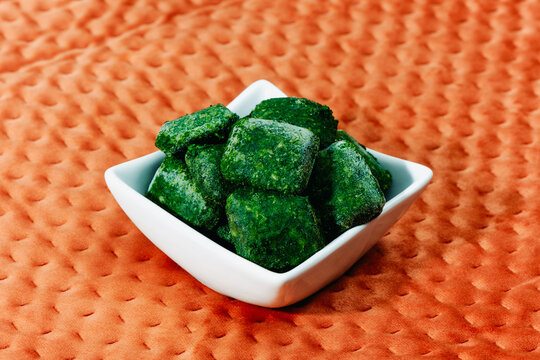 frozen cubed spinach in a square bowl