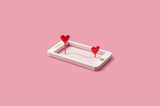 Colorful papercraft smartphone with two red hearts on screen