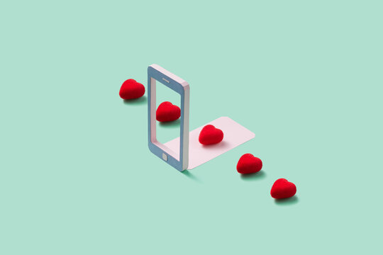 Papercraft smartphone frame with row of red hearts on blue backg