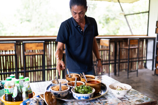 Thai man giving cooking instructions.