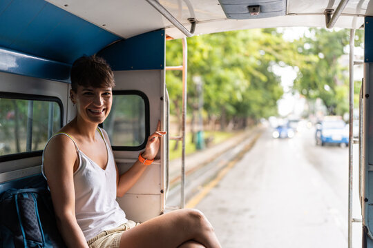 Woman smiling while traveling by bus.