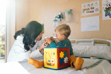 Doctor Examining a boy With Stethoscope In Hospital