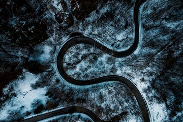 Winter's Serpentine: Aerial View of a Snowy Road