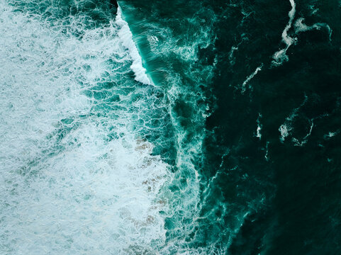 Top down aerial view of moody ocean wave