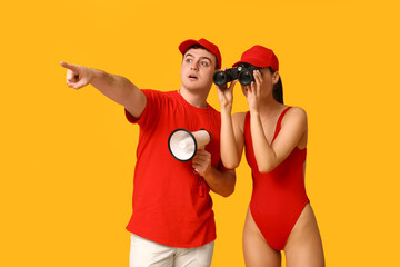Lifeguards with binoculars and megaphones spotted something on yellow background