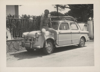 1970. Ma sitting on the hood of his car.