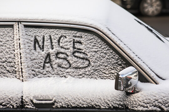 Winter Whimsy: "Nice Ass" on a Snow-Covered Car Window