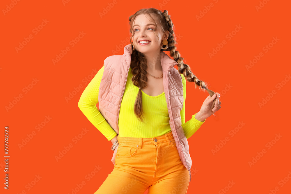 Canvas Prints Happy smiling young woman with braids on orange background