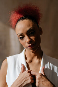 Black woman holding flaps with hands in sunlight