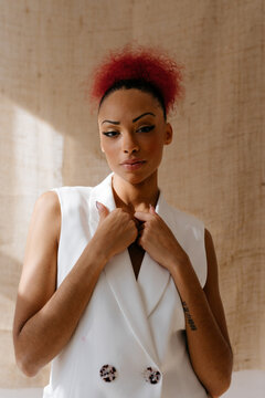 Black woman holding flaps with hands in room