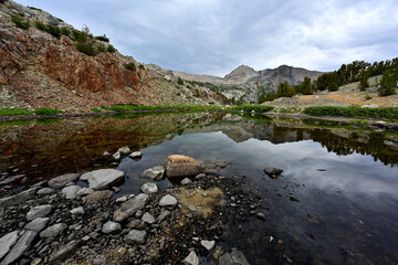 An unnamed pond reflects Excelsior Mountain in the Twenty Lakes Basin of the Sierra Nevada Mountains in California.
