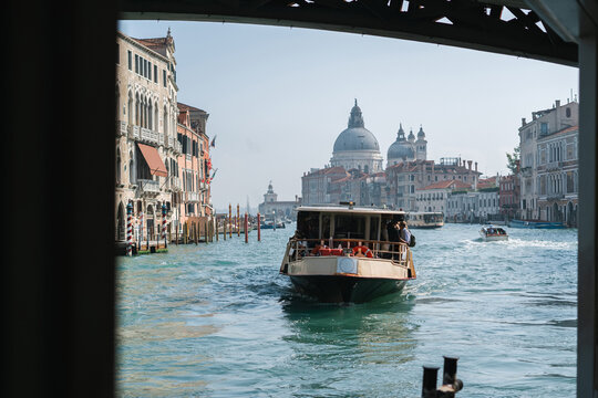 Public water bus - Vaporetto coming to terminal on Grand Canal 