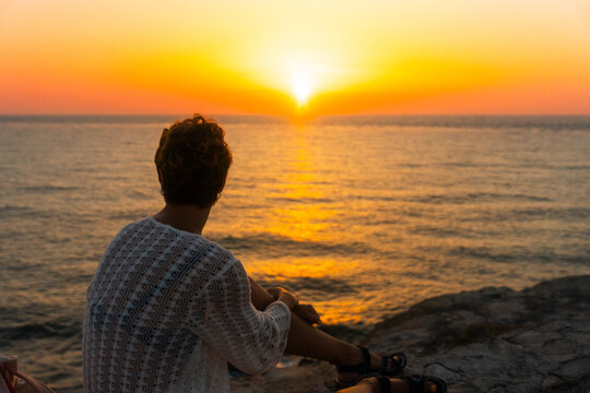 Woman Contemplating The Sunrise Near The Sea In Isla Mujeres Mexico.