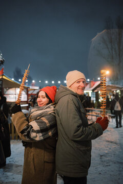 Couple Poses with Potato Swords at Christmas Market