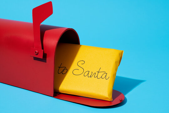 thick letter to santa in a red mailbox