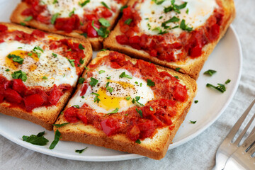 Homemade Sheet-Pan Shakshuka Toast on a Plate, side view. Close-up.
