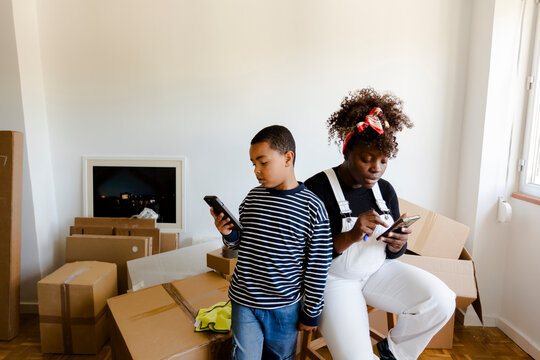 Mother and son using smartphones while moving in