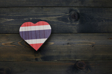 wooden heart with national flag of thailand on the wooden background.