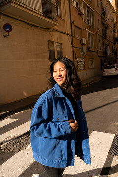 Happy woman crossing street