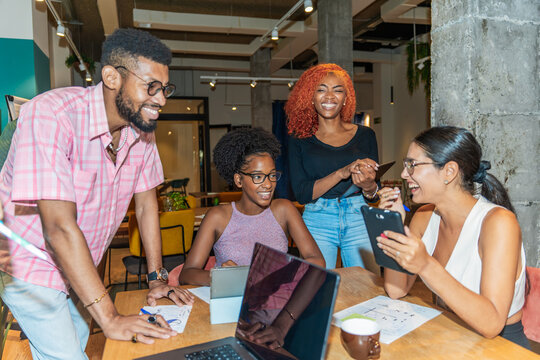 Happy Multiracial Colleagues Working In The Co-Working Office.