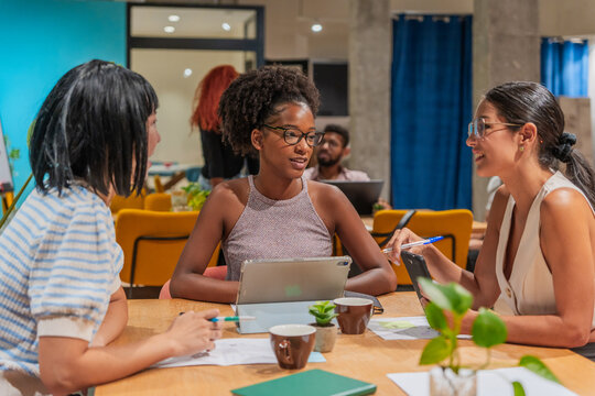Multiracial Group Of Colleagues Working In The Co-Working Office.
