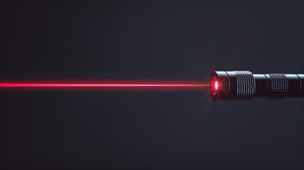 Red laser beam projecting from metal pointer against dark background - obrazy, fototapety, plakaty