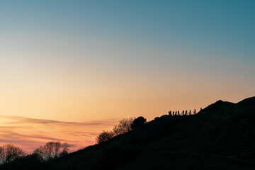 Mountain bikers silhouetted on a hill