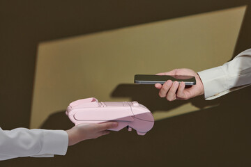 Cashier and customer hands with POS machine and smartphone,