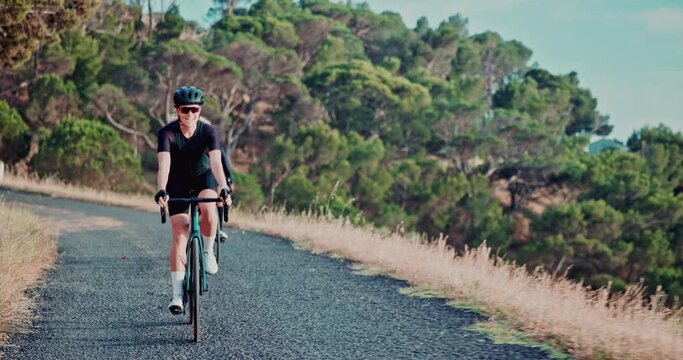 Woman, mountain and road with cyclist, fitness and exercise bike with nature and training with sunshine. Friends, bike and cycling with wellness and hobby with weekend break and activity with safety