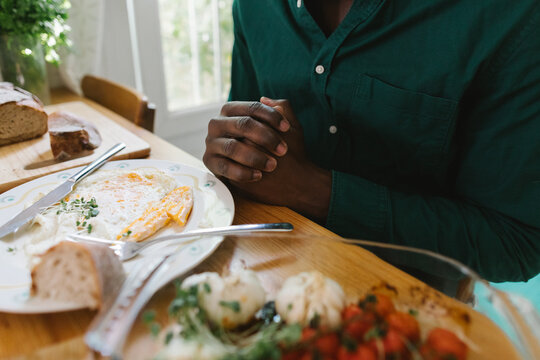 A man praying before eating
