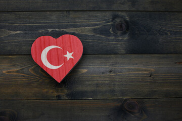 wooden heart with national flag of turkey on the wooden background.