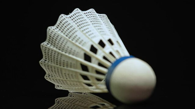 Shuttlecock focus shift, macro close up on black background. Badminton shuttlecock is part of summer hobby kit, outdoor sports, entertainment. Shallow depth of field.
