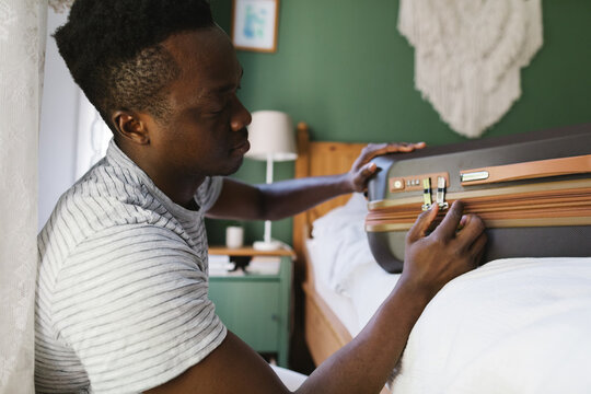 A man closing up the suitcase