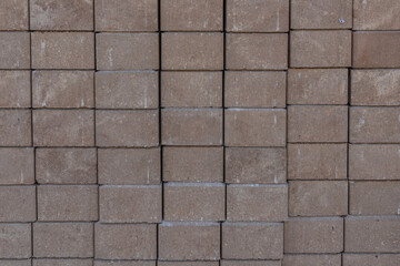 Side view of stacked brown pavers with textured background with copy space