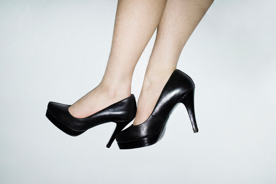 Woman with shin hair wearing heels. Image normalizing female body hair
