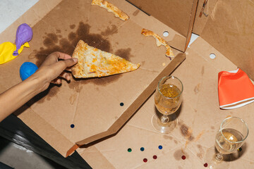 Hand Picking Pizza Slice After Party