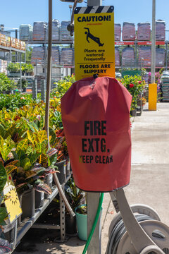 vertical view of slippery floor cautionary sign and fire extinguisher cover