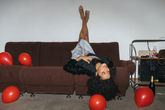 Elegant Woman Lying on Couch with Balloons