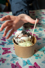 hand taking spoon ice cream with wooden spoon