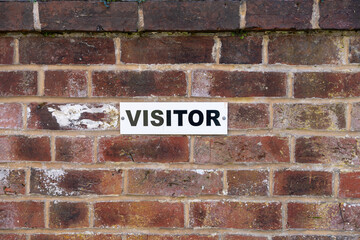 wall with visitor sign