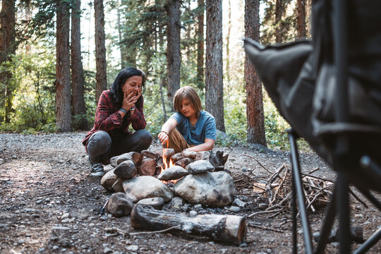 mother and son making campfire