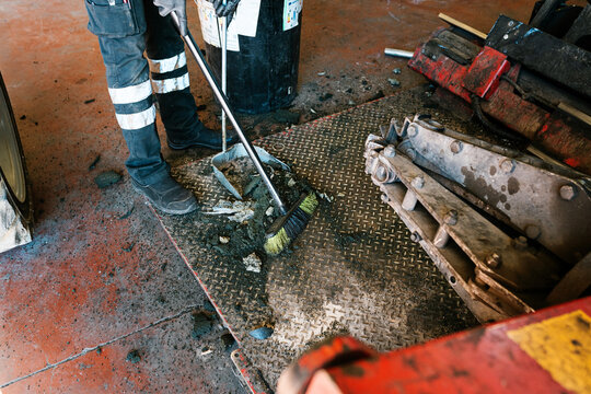 Mechanic sweeping in the mechanic shop