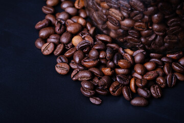 Coffee Beans in studio on a black table background with contrast and deep colors