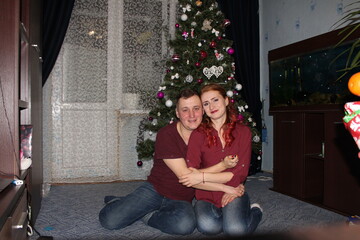 couple near the Christmas tree. the winter vacation. Christmas morning family celebrations