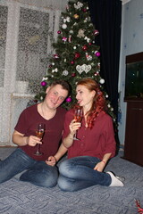 couple near the Christmas tree. the winter vacation. Christmas morning family celebrations