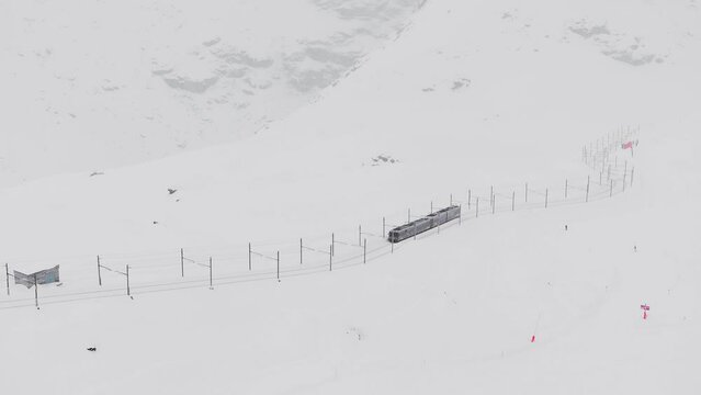 Zermatt, Switzerland - The train of Gonergratbahn running to the Gornergrat station in the famous touristic place with clear view to Matterhorn during a heavy snow storm. 