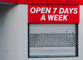 Open 7 days a week sign above business store front
